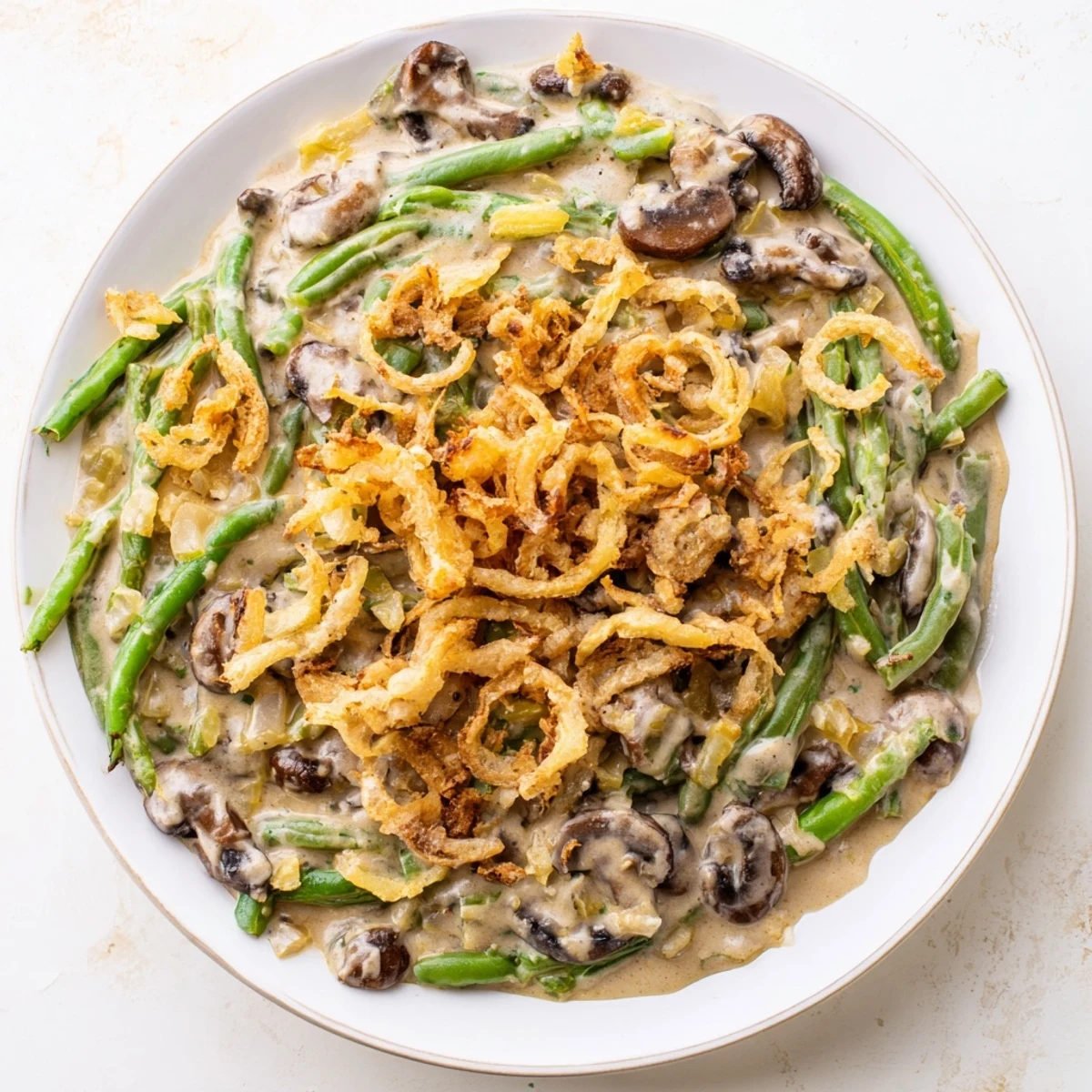 Close-up of Old-School Green Bean Casserole with golden crispy onions and creamy sauce, perfect side.