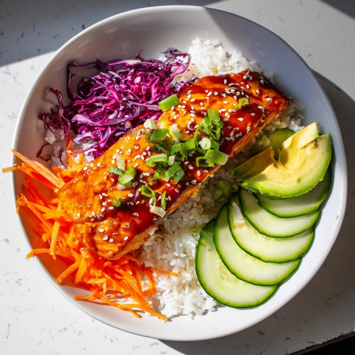 Sweet chili salmon rice bowl with vibrant colors and glistening sweet chili glaze.