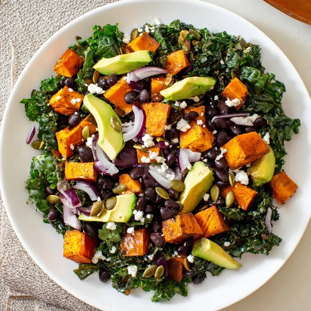 Fresh massaged kale salad with roasted sweet potato, black beans, and zesty lime dressing.