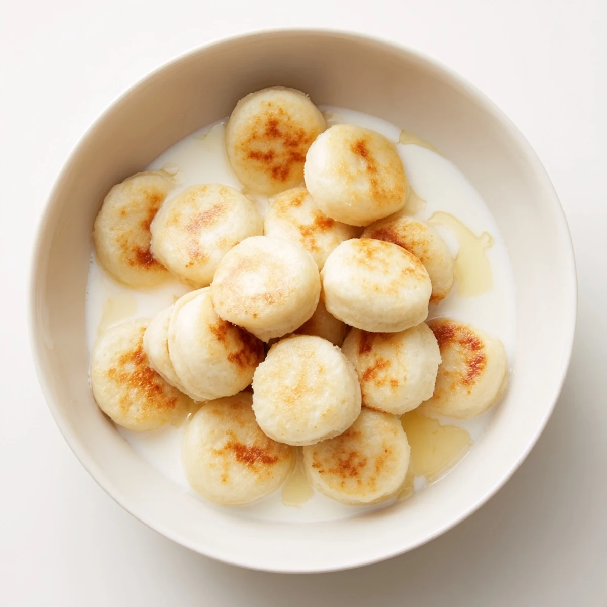 Golden and fluffy pancake cereal, perfect for a fun breakfast, served with sweet maple syrup.