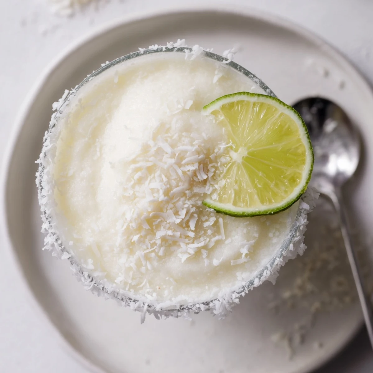 Festive White Christmas Margarita Slush, a creamy cocktail with a coconutty, lime-kissed coolness.