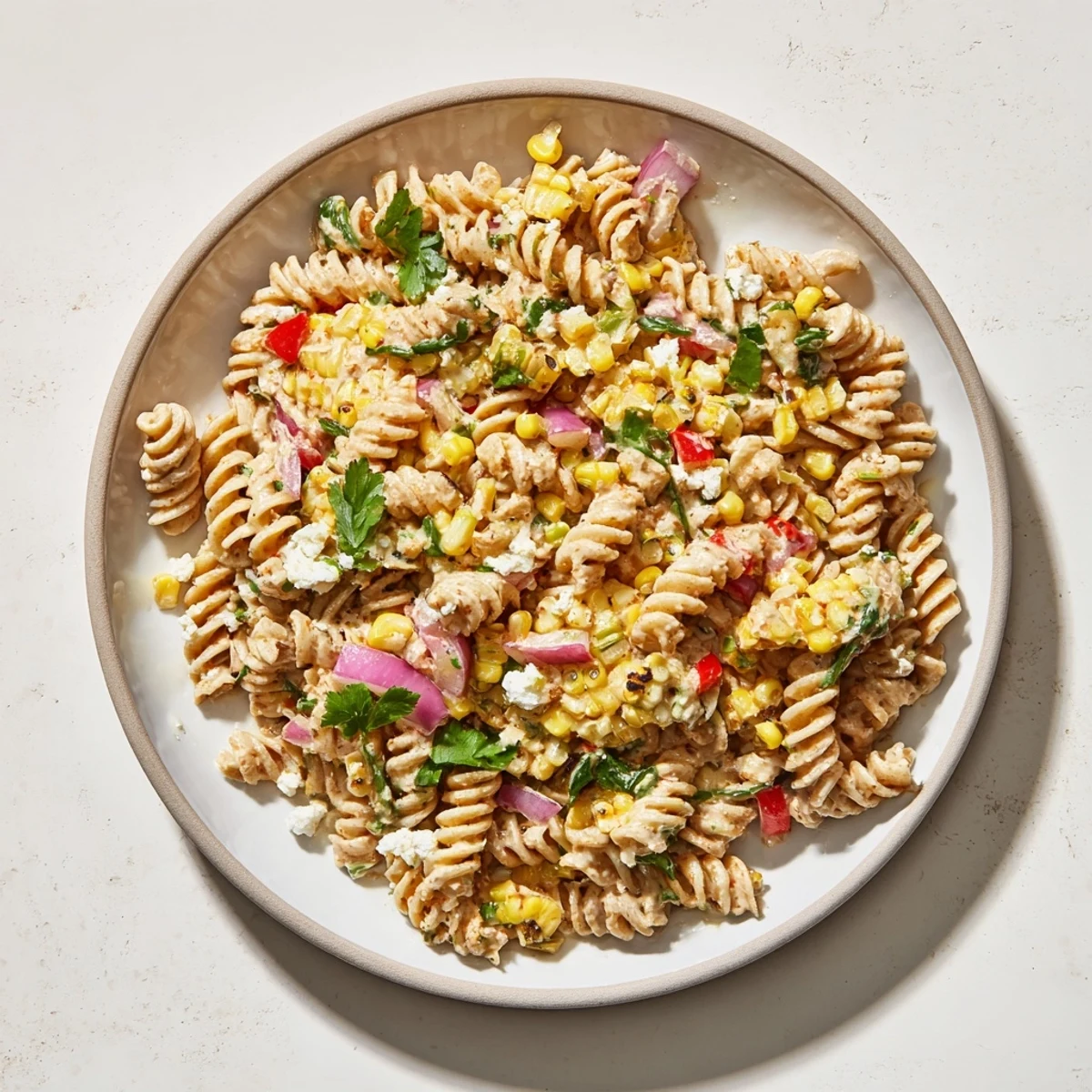 Bright, flavorful Healthier Mexican Street Corn Pasta Salad with whole wheat pasta and crumbled cotija.