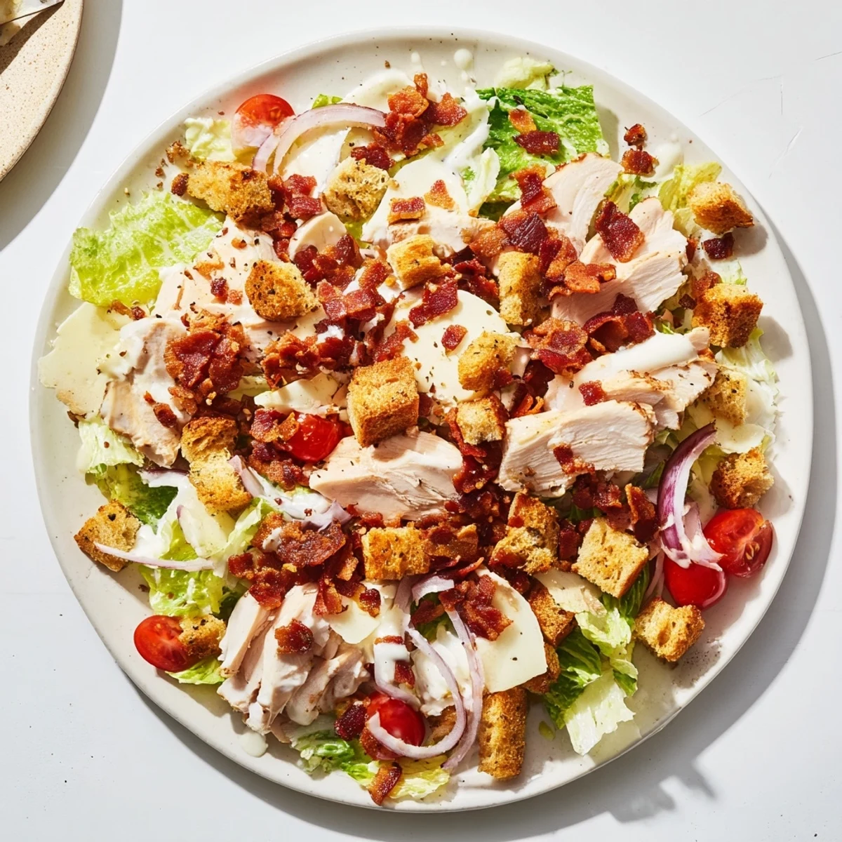 A close-up view of the delicious Costco Chicken Bake Salad Bowl loaded with cheese and bacon crumbles.