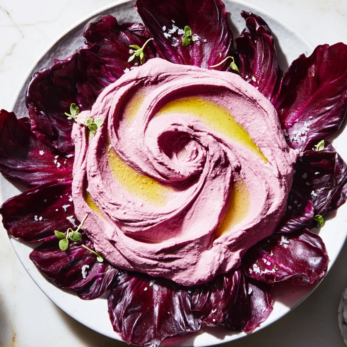 Creamy, vibrant beet hummus The Velvet Rose artfully swirled into rose shapes, served with fresh radicchio.