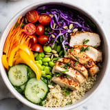 Delicious Healthy Meal-Prep Bowls topped with zesty dressing and vibrant veggies.  