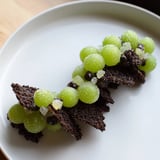The "Crystal Cave," a whimsical dessert with sugared grapes spilling from a chocolate cracker cavern, looks delicious.
