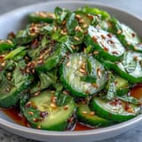 Asian Cucumber Salad with Sesame and Rice Vinegar: Refreshing salad of sliced cucumbers in a zesty rice vinegar dressing, perfect for warm days.