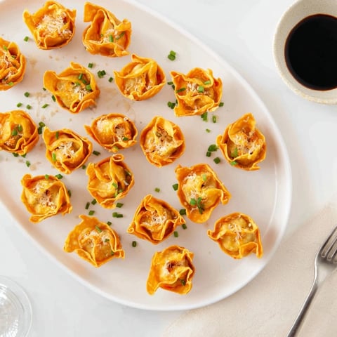 Crispy Pumpkin Wonton Bites, golden and spiced, served with sweet chili sauce.  