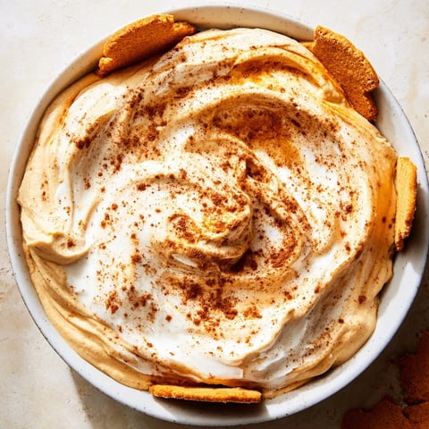 Creamy spiced pumpkin coffee whip dip garnished with cinnamon, perfect for snacks.  