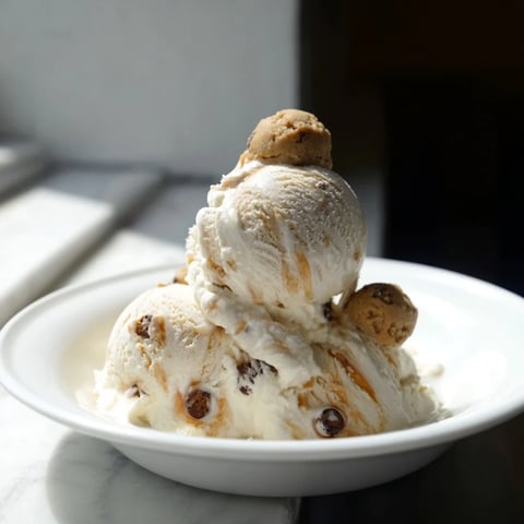 Creamy cottage cheese ice cream with chocolate chip cookie dough bites, perfect for dessert.  