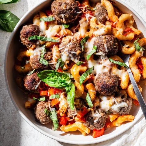 Hearty Italian Meatball Pasta Skillet with bubbling cheese and fresh basil garnish.  