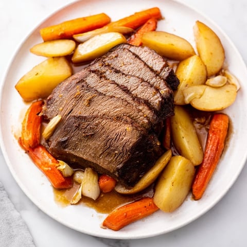 Tender Sunday Pot Roast with veggies, ready to serve with a rich, savory gravy.