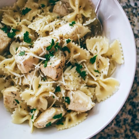 Tender Mozzarella Garlic Butter Chicken Bowties served with fresh parsley and Parmesan.  