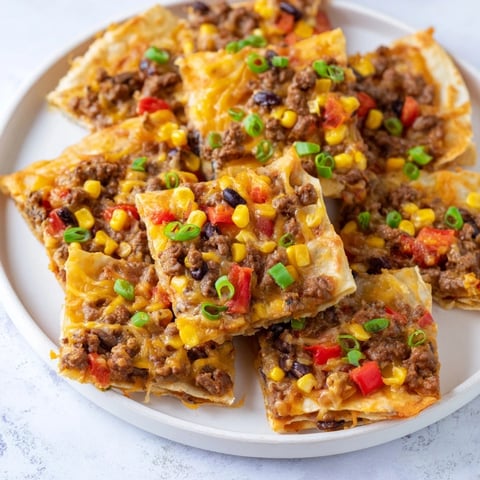 Golden, cheesy Sheet Pan Quesadillas with beef brimming with flavorful filling, ready to serve.