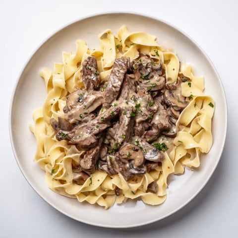 Creamy Mushroom Beef Stroganoff: A rich, beefy and mushroom-filled classic, sitting atop warm, golden egg noodles.