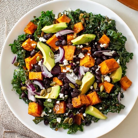 Fresh massaged kale salad with roasted sweet potato, black beans, and zesty lime dressing.
