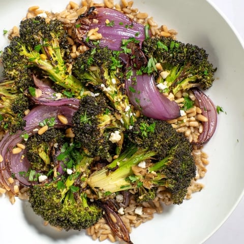 Golden roasted broccoli with garlic-lemon dressing served over fluffy farro; a delicious meal.