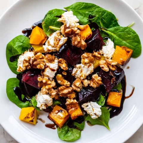 Vibrant roasted beet, butternut squash & spinach salad topped with creamy goat cheese and walnuts.