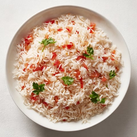 Steaming Tomato-Rice Skillet Dinner, a colorful one-pan meal with fresh parsley garnish.