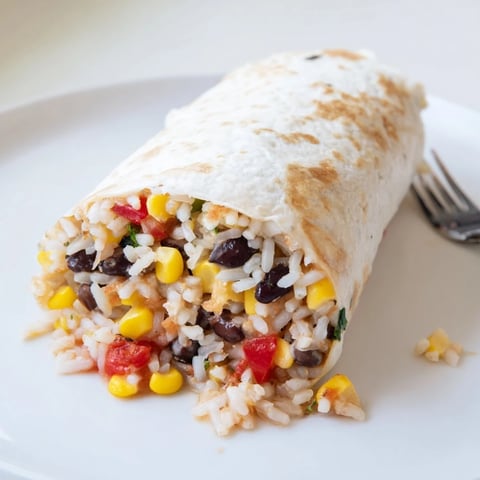 Steamy, freshly-made freezer-friendly burritos, full of savory fillings, ready for a quick meal.