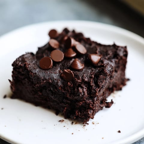 Fudgy Black Bean Brownies, topped with melty chocolate chips, ready for a delicious dessert.