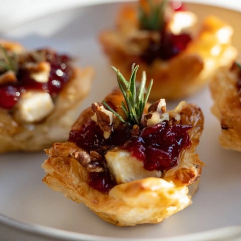 Warm, golden Quick Cranberry Brie Bites with bubbly cheese and sweet cranberry atop.