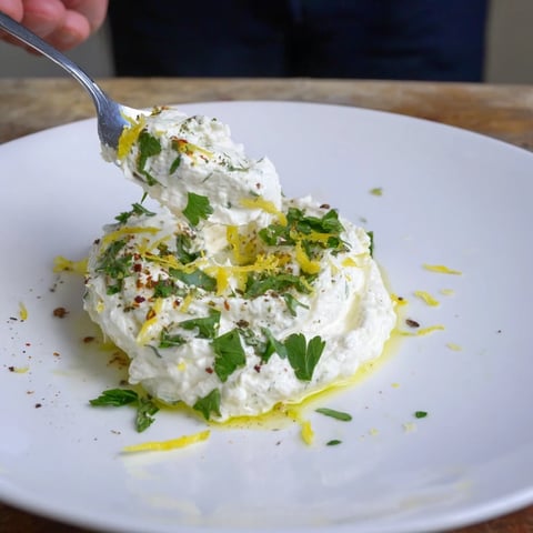 Creamy whipped feta dip, herbed and seasoned, ready to serve with warm pita and veggies.