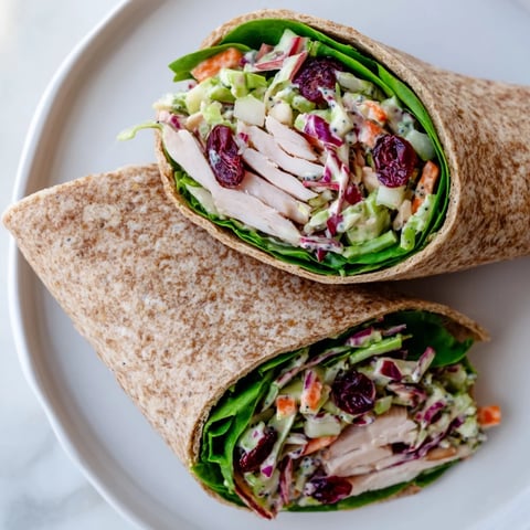 A close-up shot of a colorful Cranberry Apple Slaw Turkey Wrap ready to eat.