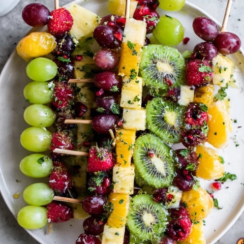 A colorful Ornament Fruit Medley, with glistening grapes and strawberries, perfect for a holiday party.