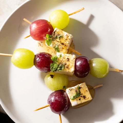 Sparkling Grape and Cheese Skewers arranged on a platter ready for your guests to enjoy.