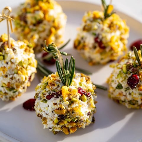 Festive Holiday Ornament Clusters, cheese balls with colorful toppings, ready for holiday appetizers.