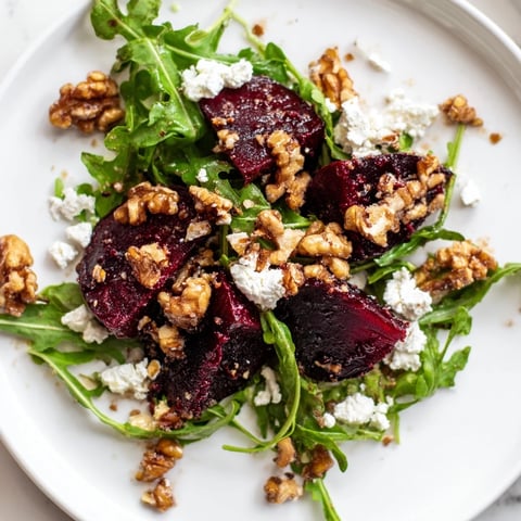 Vibrant Roasted Beet Walnut Salad with beautiful red beets, creamy goat cheese, arugula.