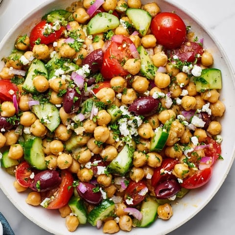 Mediterranean Chickpea Salad: A colorful mix of chickpeas, fresh vegetables, olives, and feta, beautifully presented.