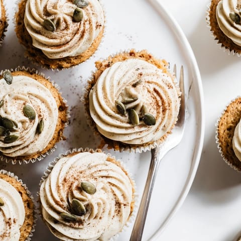Moist Vanilla Chai Pumpkin Latte Cupcakes cooling on a rack, tempting homemade autumn baking.