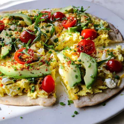 Picture a delicious Avocado Scrambled Egg Breakfast Pizza, hot from the oven, ready to slice.