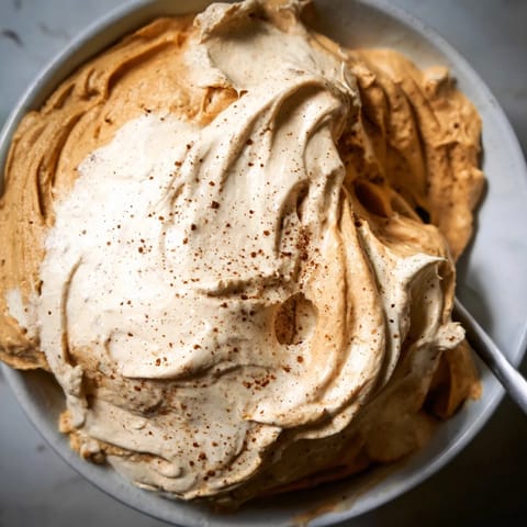 Delicious Spiced Pumpkin Coffee Whip Dip topped with a sprinkle of cinnamon.  
