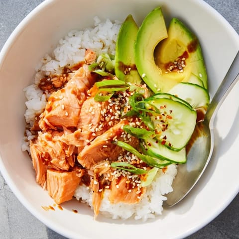 Microwave-steamed salmon paired with fresh toppings in a vibrant rice bowl.  