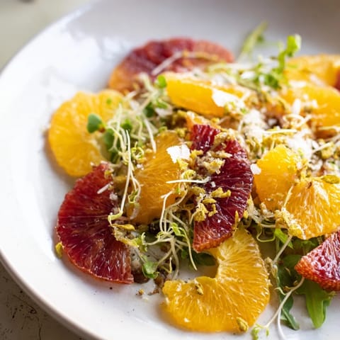 A closeup shows the beautiful Winter Citrus & Candied Pecan Salad, ready to be tossed and enjoyed.