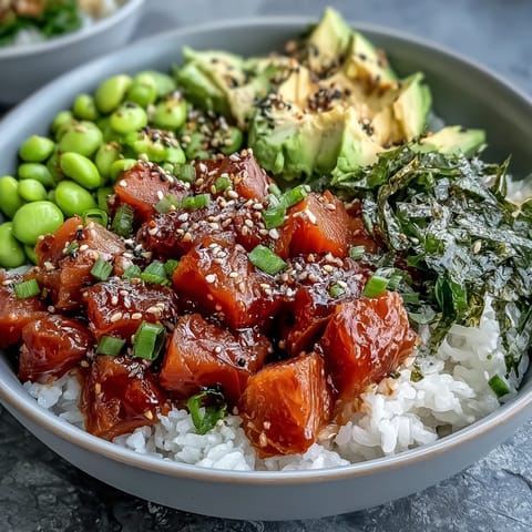 Colorful Salmon Poke Bowl with creamy avocado and edamame, a refreshing meal.