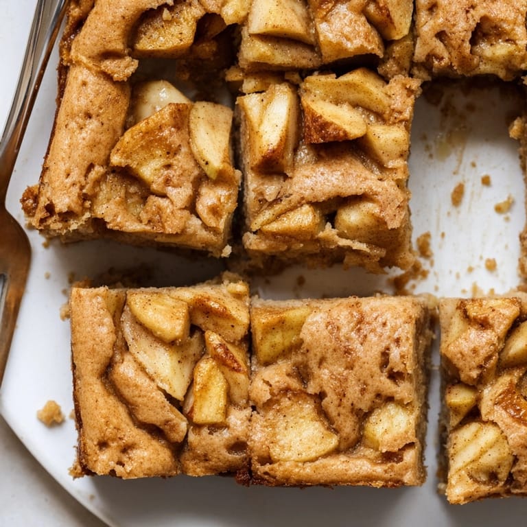 Warm, gooey Brown Butter Apple Blondies, sliced and ready to serve with vanilla ice cream.
