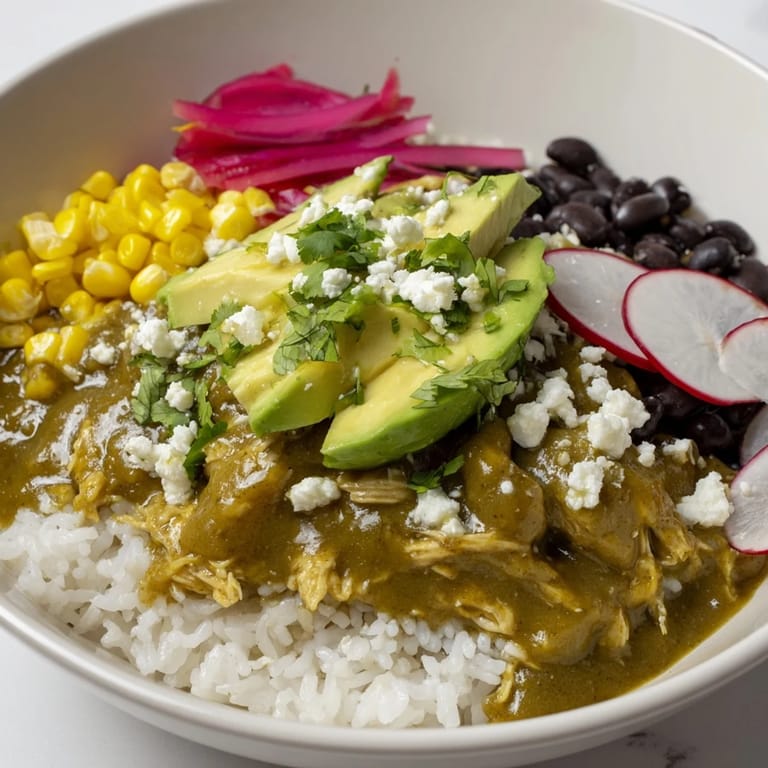 Enjoy a steaming bowl of Green Enchilada Rice Bowl, complete with cool avocado and a squeeze of lime.
