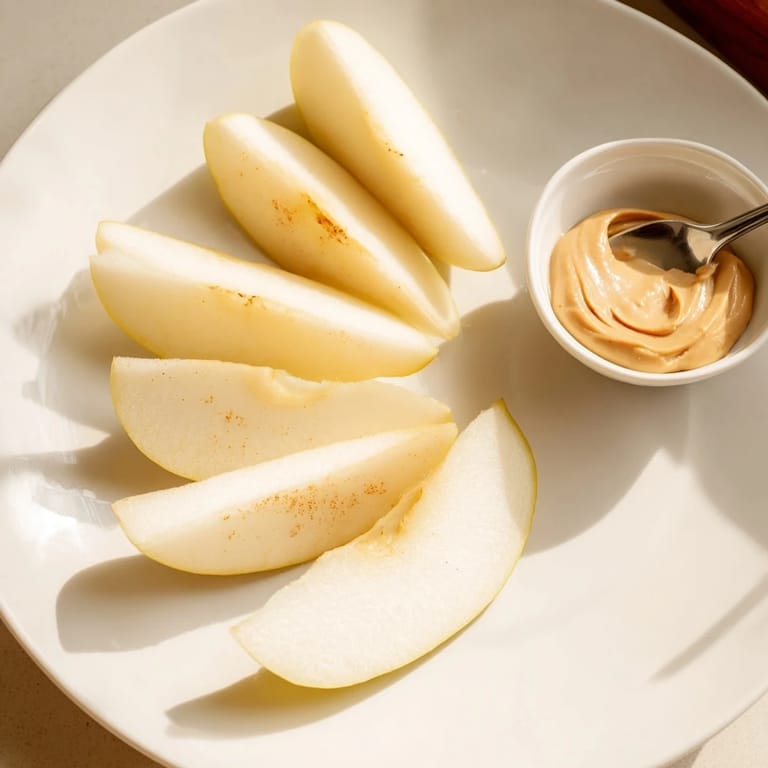 Close-up of apple slices and smooth peanut butter dip, ideal for easy, delicious snacking.