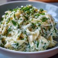 Creamy Herb Butter Orzo dish topped generously with fresh parsley and Parmesan.