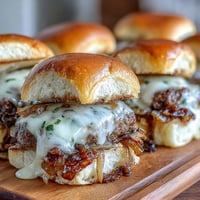 Golden brown French onion smash burger sliders with melted Gruyère cheese.